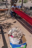 A man weaving on a wooden foot loom in Seclantas, Argentina in the Calchaqui Valley.