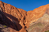 Striated rock layers in the Hill of Seven Colors or Cerro de los Siete Colores in Purmamarca, Argentina.