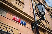 Street name plaque and streetlight in Prague