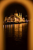 Illuminated Parliament building and Danube River it night, Budapest, Hungary, Europe