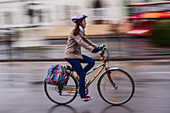 Moving female bicycle rider in Budapest