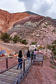 Tourists descend the stairs from the viewpoint for the Hill of Seven Colors or Cerro de los Siete Colores in Purmamarca, Argentina.