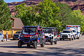 Decorated OHVs or Off Highway Vehicles with American flags in the Fourth of July Parade on Independence Day in Moab, Utah.