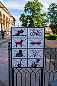 Sign forbids running, dogs, skateboarding, smoking, scooters, the use of bikes and throwing trash at Queen Anne's Summer Palace, Prague