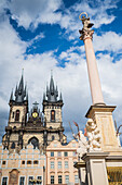 Marian Column (Mariánský sloup) in front on the Tyn Church (Týnský chrám) in Old Town Square (Staromestské námestí) in Prague