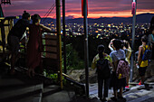 People enjoy the night views of Kyoto from viewpoint at Fushimi Inari Taisha temple, Kyoto, Japan