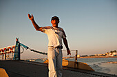 Seville, Spain, Aug 7 2008, A sailor skillfully directs a barge transporting passengers across the Guadalquivir river in Sanlucar de Barrameda.