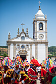 Parade passing by São João Baptista Church during The Festival of Saint John of Sobrado, also known as Bugiada and Mouriscada de Sobrado, takes place in the form of a fight between Moors and Christians , locally known as Mourisqueiros and Bugios, Sao Joao de Sobrado, Portugal