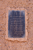 Bronze plaque on the adobe bell tower of the Santa Barbara church in Humahuaca in the Quebrada de Humahuaca, Argentina.