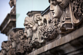 Intricate stone sculptures adorn the Reichstag building in Berlin, highlighting its architectural beauty and historical significance.