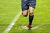 The referee navigates a flooded field during a game