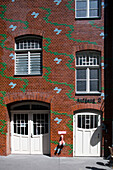 The vibrant Art Nouveau tiles adorn the brick wall of Hackeschen H?fe, showcasing the unique architectural style in Berlin\'s Mitte district.