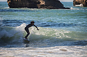 Surfers in Grande Plage beach of Biarritz, France