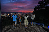 People enjoy the night views of Kyoto from viewpoint at Fushimi Inari Taisha temple, Kyoto, Japan