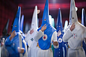 Colorful figures of nazarenos are showcased for sale in a Semana Santa shop in Sevilla, capturing the essence of the tradition.