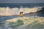 Man surfing on the beach in front of Finca Barlovento, Tayrona National Park, Colombia