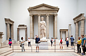 Berlin, Germany, July 24 2009, Visitors admire Hellenistic architecture pieces from Magnesia and Priene in the Pergamon Museum\'s spacious interior.