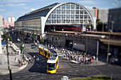 Berlin, Germany, July 21 2009, Visitors navigate through Alexanderplatz as a tram glides past the iconic railway station in Berlin, capturing urban life.