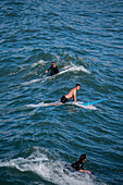 Surfers in Grande Plage beach of Biarritz, France