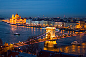 Illuminated Parliament building, Chain Bridge and Danube River at night, Budapest, Hungary, Europe