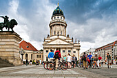 Berlin, Germany, July 24 2009, Cyclists gather in Gendarmenmarkt square, enjoying the backdrop of the French Cathedral in Berlin, Germany on a cloudy day.