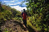 Young man hiking in the mountains of Sierra Nevada de Santa Marta, Colombia