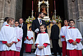 Seville, Spain, June 11 2009, Altar boys gather at the entrance of a church, dressed in traditional attire for the Corpus Christi procession in Seville, 2009.