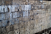 The historic stone wall by the Spree river shows visible bullet holes, remnants of World War II in Berlin, Germany.