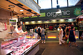 Barcelona, Spain, Sept 4 2008, A butcher shop is located next to a vegetarian market, showcasing the diverse culinary options at Mercat de la Boqueria in Barcelona.