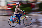 Moving female bicycle rider in Budapest