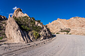 Route 40, an unpaved dirt road through the eroded landscape of the Angastaco Natural Monument in the Calchaqui Valley, Argentina.