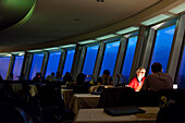 Berlin, Germany, July 27 2009, Guests enjoy a meal in the panoramic restaurant of Berlin\'s iconic TV Tower during twilight, surrounded by stunning city views.