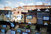 A variety of cheeses showcased in a shop at Mercat de la Boqueria in Barcelona, highlighting local flavors in the vibrant market setting.