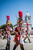 Parade passing by São João Baptista Church during The Festival of Saint John of Sobrado, also known as Bugiada and Mouriscada de Sobrado, takes place in the form of a fight between Moors and Christians , locally known as Mourisqueiros and Bugios, Sao Joao de Sobrado, Portugal