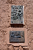 Bronze plaque on the adobe bell tower of the Santa Barbara church in Humahuaca in the Quebrada de Humahuaca, Argentina.