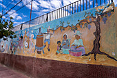 A wall mural depicting people making wine in Cafayate, Argentina.