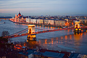 Illuminated Parliament building, Chain Bridge and Danube River at night, Budapest, Hungary, Europe