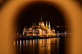 Illuminated Parliament building and Danube River it night, Budapest, Hungary, Europe