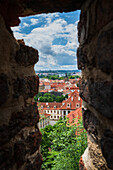 View of Prague skyline through a rock wall in Prague Castle