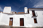 Explore the charming whitewashed buildings of Monsaraz, a historic village in Alentejo, Portugal surrounded by stunning landscapes.