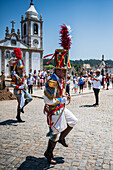 Parade passing by São João Baptista Church during The Festival of Saint John of Sobrado, also known as Bugiada and Mouriscada de Sobrado, takes place in the form of a fight between Moors and Christians , locally known as Mourisqueiros and Bugios, Sao Joao de Sobrado, Portugal