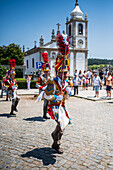 Parade passing by São João Baptista Church during The Festival of Saint John of Sobrado, also known as Bugiada and Mouriscada de Sobrado, takes place in the form of a fight between Moors and Christians , locally known as Mourisqueiros and Bugios, Sao Joao de Sobrado, Portugal