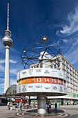 Berlin, Germany, July 27 2009, The Urania Weltzeituhr displays current times from various cities while the Fernsehturm towers above in Alexanderplatz, Berlin.