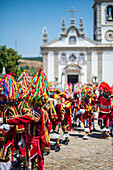 Parade passing by São João Baptista Church during The Festival of Saint John of Sobrado, also known as Bugiada and Mouriscada de Sobrado, takes place in the form of a fight between Moors and Christians , locally known as Mourisqueiros and Bugios, Sao Joao de Sobrado, Portugal