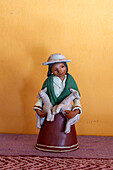 A ceramic Aymara woman with lambs by indigenous Aymara ceramic artist Santina Alabar in Purmamarca, Argentina.