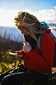 Woman using her smartphone in Sierra Nevada de Santa Marta