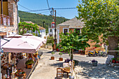 View of souvenir shop and clock tower of Greek Orthodox Church, Theologos, Thassos, Aegean Sea, Greek Islands, Greece, Europe