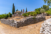 View of dry stone walls and clock tower of Greek Orthodox Church, Theologos, Thassos, Aegean Sea, Greek Islands, Greece, Europe