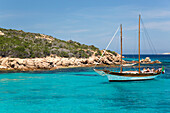 Wooden sailing boat anchored in clear turquoise water off Cala Granara, Spargi Island, La Maddalena Archipelago National Park, Sassari, Sardinia, Italy, Mediterranean, Europe