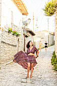 Woman posing on the street in Berat, Albania, Europe